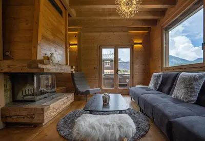 a living room with a couch and a fireplace at Grosse Pierre Chalet 180m2 Cheminee Jacuzzi Vue Taconnaz in Les Houches