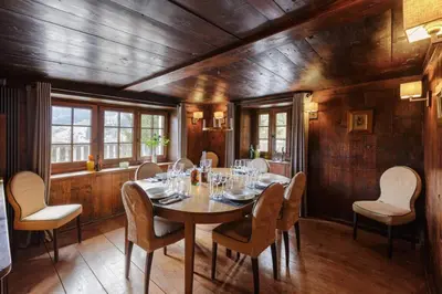 a dining room with a table and chairs at Peter Pan Chalet Luxe Sauna Jacuzzi Cinema Vue 180 in Les Houches