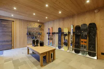 a room with a bunch of snowboards on a wall at Peter Pan Chalet Luxe Sauna Jacuzzi Cinema Vue 180 in Les Houches