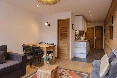a living room with a couch and a table at Vallee Blanche Central 4pax Vue MtBlanc Parking 400m Remontee in Chamonix-Mont-Blanc