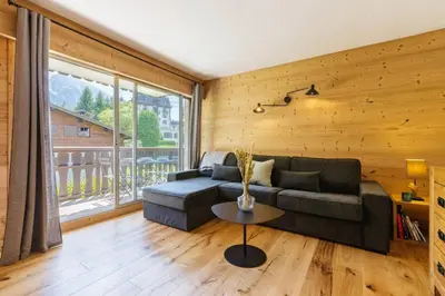 a living room with a couch and a table at Closy Modern 4pax Pied Piste Centre Balcon Parking in Chamonix-Mont-Blanc