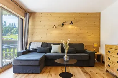 a living room with a couch and a table at Closy Modern 4pax Pied Piste Centre Balcon Parking in Chamonix-Mont-Blanc