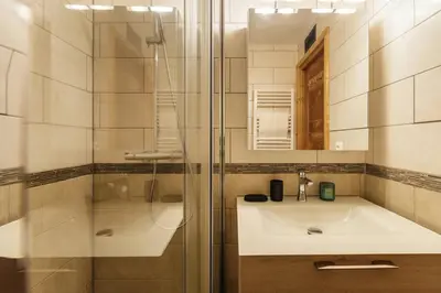 a bathroom with a sink and a glass shower at Closy Modern 4pax Pied Piste Centre Balcon Parking in Chamonix-Mont-Blanc