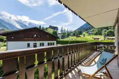a balcony with a chair and a view of a mountain at Closy Modern 4pax Pied Piste Centre Balcon Parking in Chamonix-Mont-Blanc