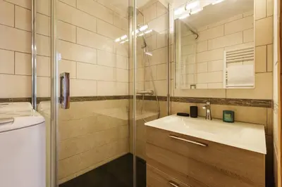 a bathroom with a sink and a glass shower at Closy Modern 4pax Pied Piste Centre Balcon Parking in Chamonix-Mont-Blanc