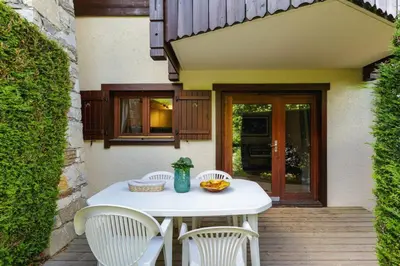 a white table and chairs on a patio at Chavants Apart 3CH Famille Pied Piste Piscine Parking in Les Houches