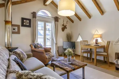 a living room with a couch and a table at Moulin - Ultra Central T2 - Vue Mt Blanc - Quartier Vivant in Chamonix-Mont-Blanc