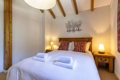 a bedroom with a white bed with two pillows at Moulin - Ultra Central T2 - Vue Mt Blanc - Quartier Vivant in Chamonix-Mont-Blanc