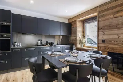 a kitchen with a table and chairs in a kitchen at Ocma 4 Somptueux 6pax Central Parking Confort in Chamonix-Mont-Blanc