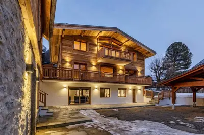 a large wooden house with a balcony on it at Ocma3 Somptueux 6pax VueMtBlanc Central Parking in Chamonix-Mont-Blanc