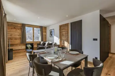 a dining room with a table and chairs at Jacaranda2 Sublime 6pax Vue MtBlanc Central Parking in Chamonix-Mont-Blanc