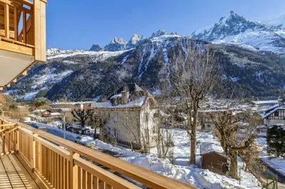 a balcony with a view of a snow covered mountain at Jacaranda2 Sublime 6pax Vue MtBlanc Central Parking in Chamonix-Mont-Blanc