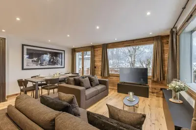a living room with a couch and a table at Jacaranda1 Sublime 8pax 100m2 Vue MtBlanc Central Parking in Chamonix-Mont-Blanc