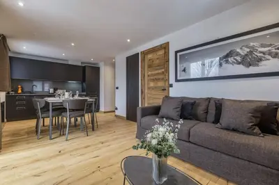 a living room with a couch and a table at Jacaranda3 Sublime 6pax Vue MtBlanc Central Parking in Chamonix-Mont-Blanc
