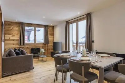 a dining room with a table and chairs and a couch at Jacaranda3 Sublime 6pax Vue MtBlanc Central Parking in Chamonix-Mont-Blanc