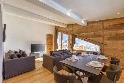 a dining room with a table and some chairs at Jacaranda4 Sublime 6pax 80m2 Vue MtBlanc Central Parking in Chamonix-Mont-Blanc