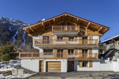 a large house with a balcony and a mountain at Jacaranda4 Sublime 6pax 80m2 Vue MtBlanc Central Parking in Chamonix-Mont-Blanc