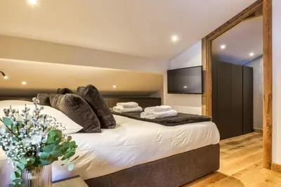a bedroom with a large bed with a large mirror at Jacaranda4 Sublime 6pax 80m2 Vue MtBlanc Central Parking in Chamonix-Mont-Blanc