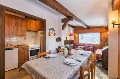 a kitchen with a table with chairs and a tableablish at La Loriaz Chalet 7pax Nature Le Planet 5mn Argentiere in Chamonix-Mont-Blanc
