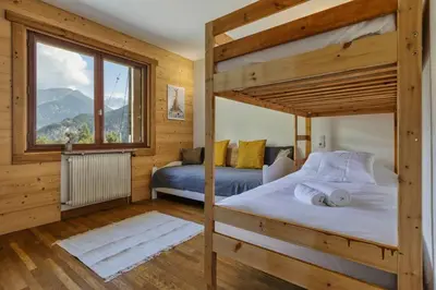 a bedroom with two bunk beds and a large window at Passy Appart 7pax Vue Vallee Monts Balcon Lumineux in Passy