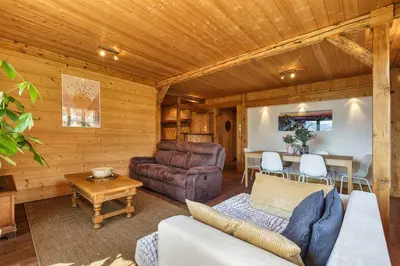 a living room with a couch and a table at Passy Appart 7pax Vue Vallee Monts Balcon Lumineux in Passy