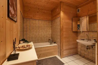 a bathroom with a bath tub and a sink at Passy Appart 7pax Vue Vallee Monts Balcon Lumineux in Passy