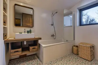 a bathroom with a sink and a tub and a mirror at Le Murger Chalet de Luxe 240m2 6 CH Vue MtBlanc Sauna in Chamonix-Mont-Blanc