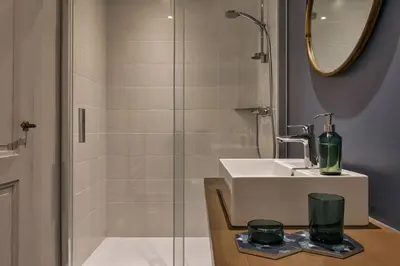 a bathroom with a sink and a shower at Le Murger Chalet de Luxe 240m2 6 CH Vue MtBlanc Sauna in Chamonix-Mont-Blanc