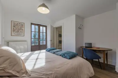 a bedroom with a bed with blue pillows on it at Le Murger Chalet de Luxe 240m2 6 CH Vue MtBlanc Sauna in Chamonix-Mont-Blanc
