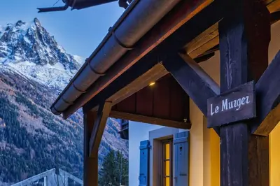 a sign on the side of a building with a mountain at Le Murger Chalet de Luxe 240m2 6 CH Vue MtBlanc Sauna in Chamonix-Mont-Blanc