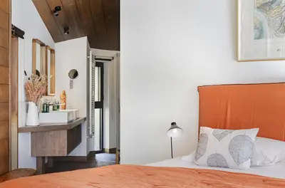 a bedroom with a bed with a wooden headboard at Le Murger Chalet de Luxe 240m2 6 CH Vue MtBlanc Sauna in Chamonix-Mont-Blanc