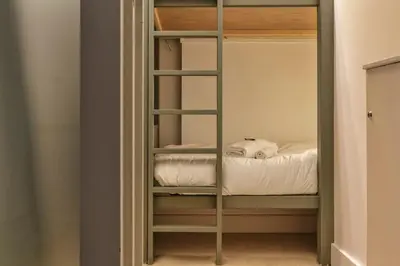 a room with a bunk bed in a room at Bios Moderne 3CH Vue Mt Blanc Aiguilles 3mn Brevent in Chamonix-Mont-Blanc