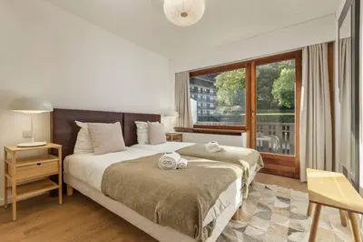 a bedroom with a bed and a large window at Bios Moderne 3CH Vue Mt Blanc Aiguilles 3mn Brevent in Chamonix-Mont-Blanc