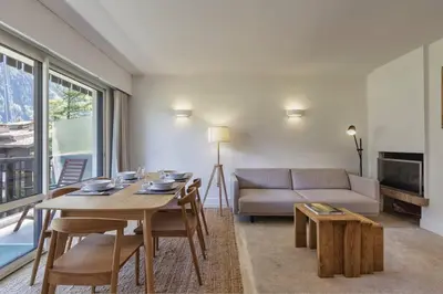 a living room with a table and a couch at Bios Moderne 3CH Vue Mt Blanc Aiguilles 3mn Brevent in Chamonix-Mont-Blanc