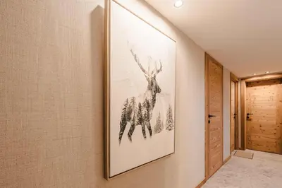a picture of a deer on a wall in a hallway at Luxury Chalet with Private Spa & Wellness Area in Megève