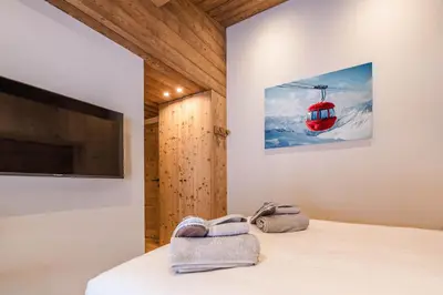 a room with a bed and a ski lift at Luxury Chalet with Private Spa & Wellness Area in Megève