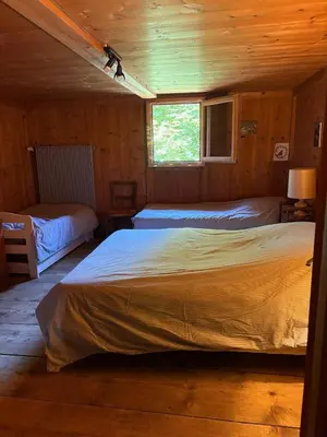 a bedroom with two beds in a wooden cabin at La CHACUNIERE GRAND CHALET ST NICOLAS DE VEROCE, PRES DES PISTES in La Chapelle
