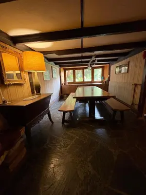 a dining room with a wooden table and benches at La CHACUNIERE GRAND CHALET ST NICOLAS DE VEROCE, PRES DES PISTES in La Chapelle