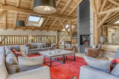a living room with couches and a fireplace at Chalet exceptionnel de 600m2 - Spa, salle de gym, ski-room in Samoëns