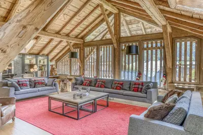 a large living room with couches and a table at Chalet exceptionnel de 600m2 - Spa, salle de gym, ski-room in Samoëns