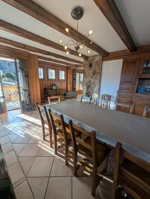 a large dining room with a large table and chairs at Chez Math et Lolo in Sallanches