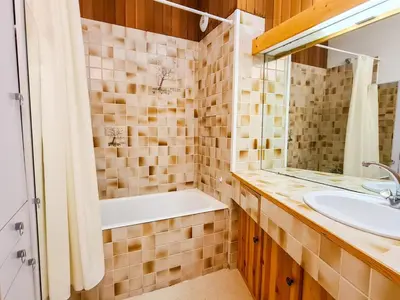 a bathroom with a tub and a sink at Studio spacieux au pied des pistes avec terrasse et WIFI - FR-1-425-239 in Arâches-la-Frasse