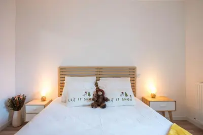 a bedroom with a bed with two teddy bears on the pillows at Capucines des Alpes - Au pied du Mont Blanc in Saint-Gervais-les-Bains