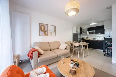 a living room with a couch and a table at Capucines des Alpes - Au pied du Mont Blanc in Saint-Gervais-les-Bains