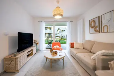 a living room with a couch and a tv at Capucines des Alpes - Au pied du Mont Blanc in Saint-Gervais-les-Bains