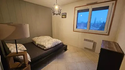 a bedroom with a bed and a window at Ecrin du Mont-Blanc - Duplex Panoramique in Sallanches