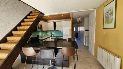 a kitchen and dining room with a table and chairs at Ecrin du Mont-Blanc - Duplex Panoramique in Sallanches
