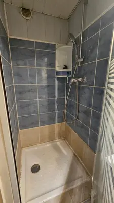 a shower in a bathroom with blue tiles at Ecrin du Mont-Blanc - Duplex Panoramique in Sallanches