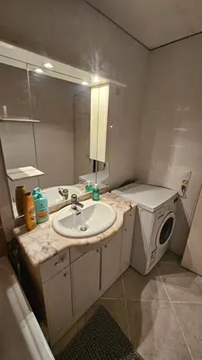 a bathroom with a sink and a washing machine at Ecrin du Mont-Blanc - Duplex Panoramique in Sallanches