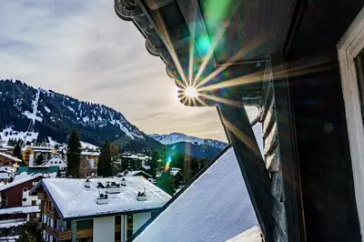 a view from a window of a snow covered mountain at Alpine Mood - Proche des pistes et Centre ville in Megève